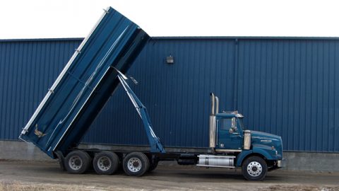 Blue Harsh International truck with hydraulic bed fully extended